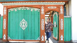 A traveler stands in a colorful doorway in Ulaanbaatar, the capital city of Mongolia, where the adventure travel company is launching a new rail itinerary in 2025.